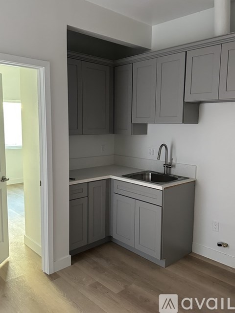A kitchen with a stove top oven and a sink.
