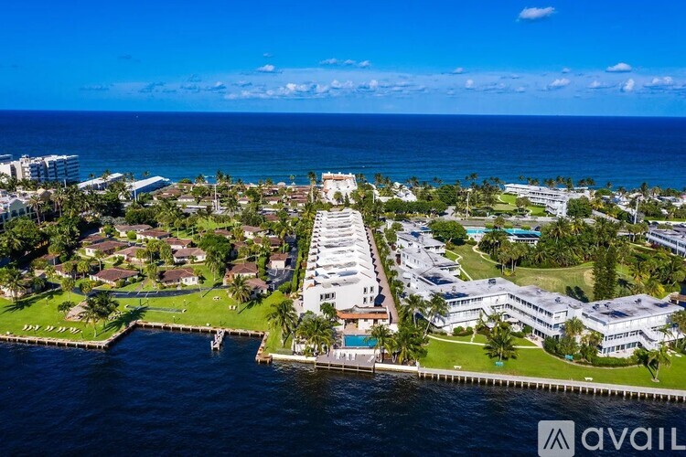 A bird's eye view of a coastal residential area with a marina.