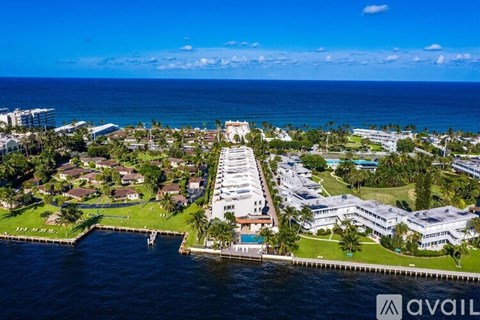A bird's eye view of a coastal residential area with a marina.