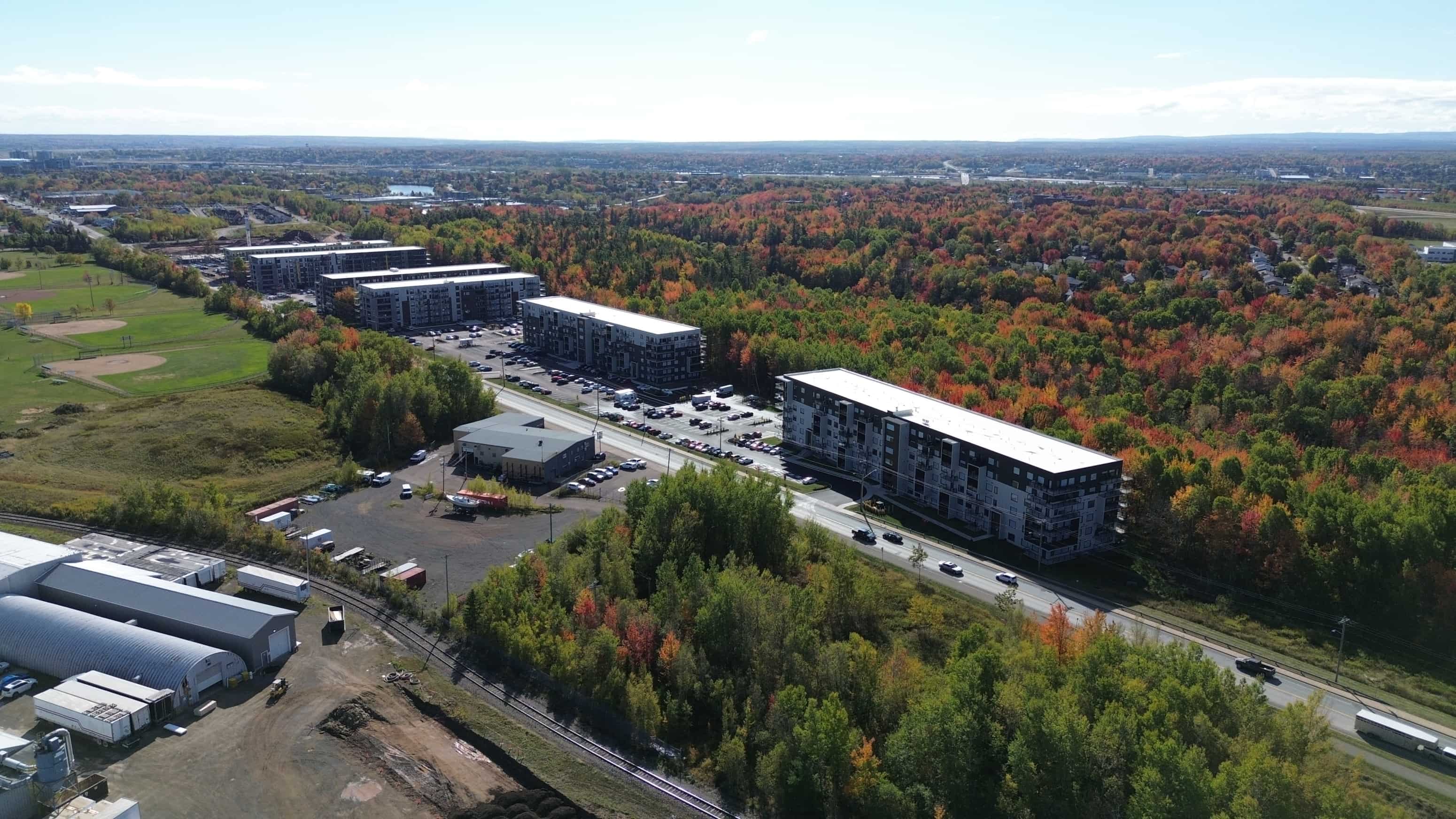 An aerial view of a large industrial area with multiple buildings and a parking lot.