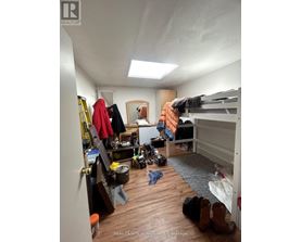 A bedroom with a bunk bed and a desk with a chair.