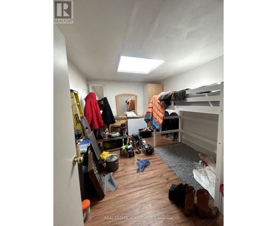 A bedroom with a bunk bed and a desk with a chair.