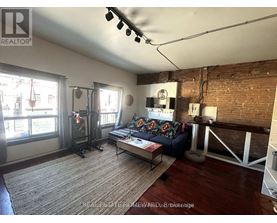 A living room with a couch, a coffee table, and a fireplace.