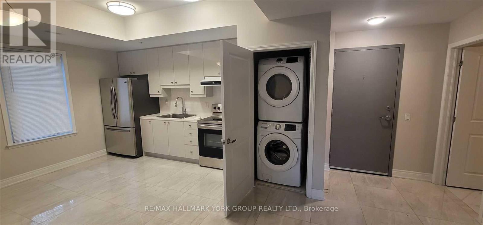 A laundry room with a washer and dryer stacked on top of each other.