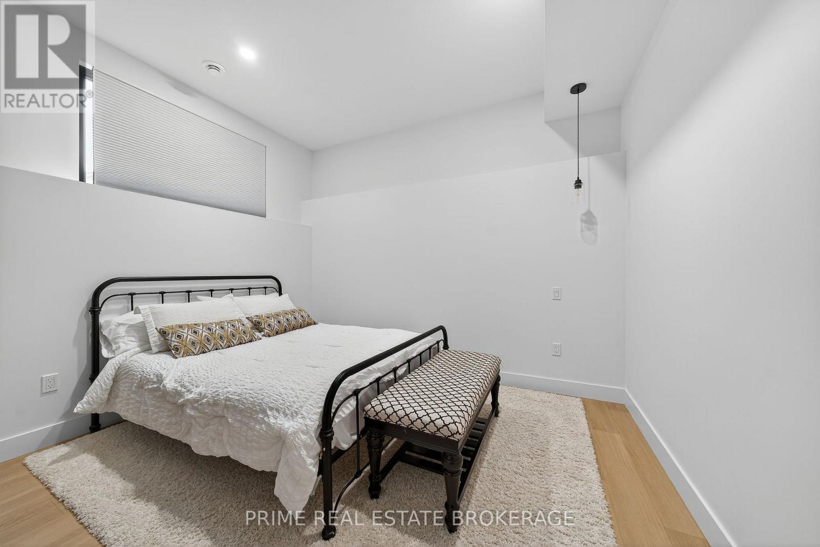 A bedroom with a bed and a chair.
