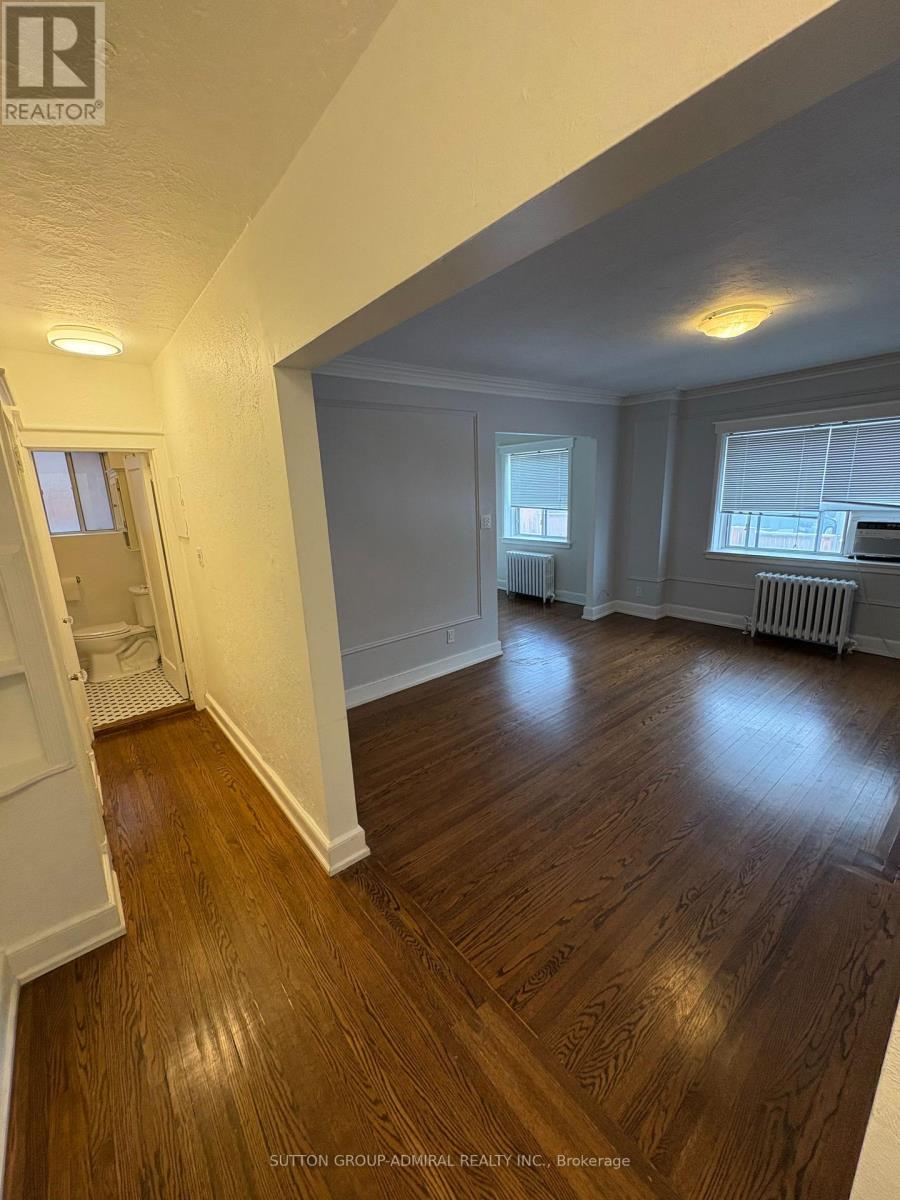 A room with wooden floors and white walls.