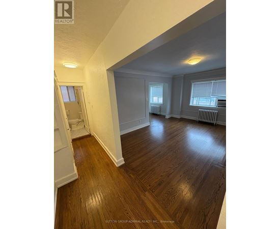A room with wooden floors and white walls.