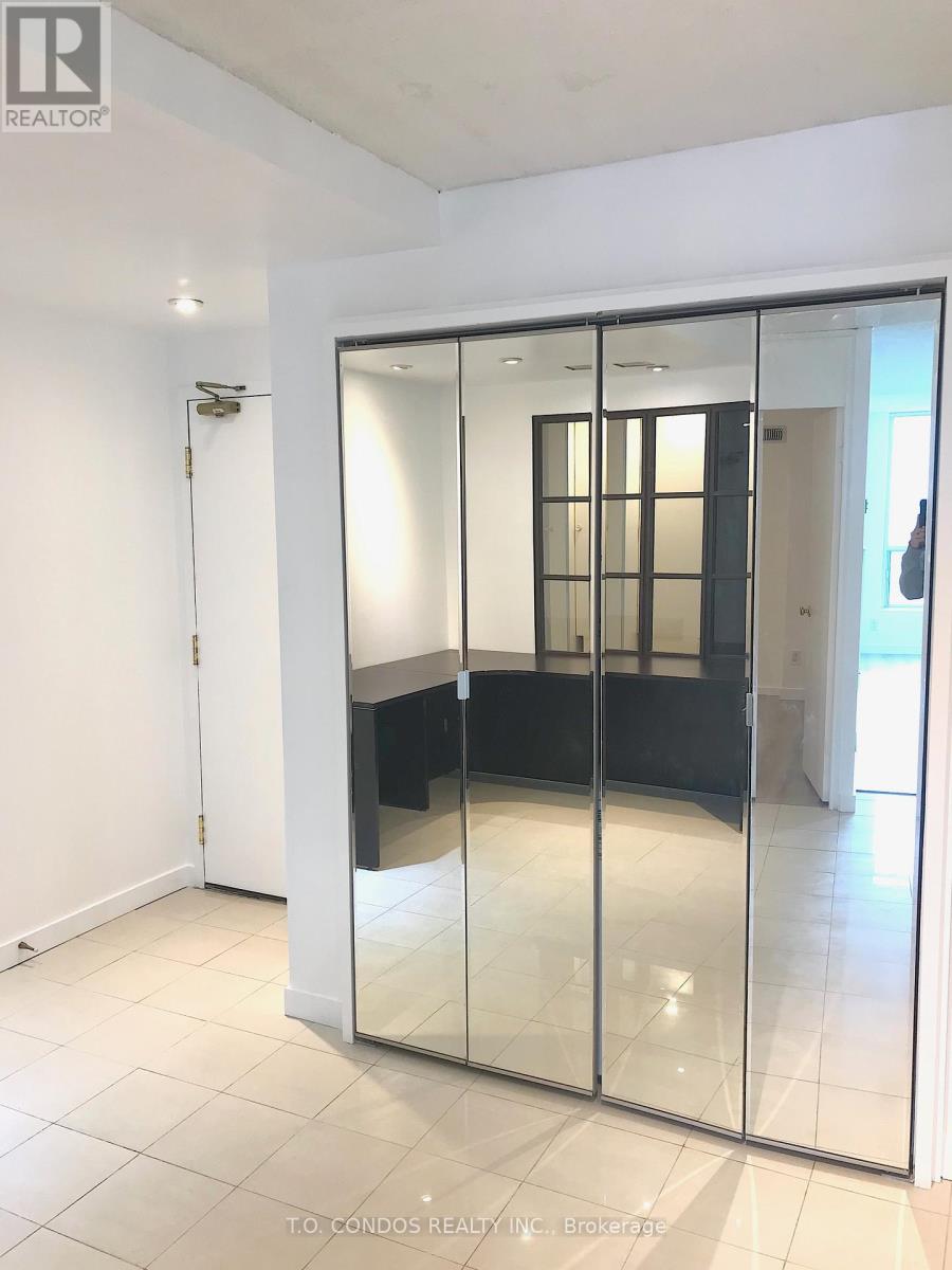 A room with a glass door and a white wall.