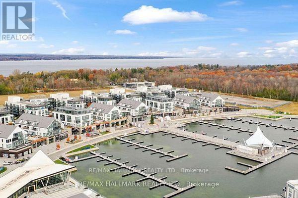 A marina with boats and buildings in the background.