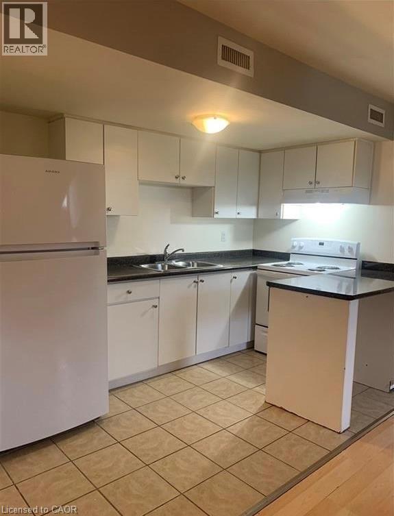 A kitchen with white appliances and white cabinets.
