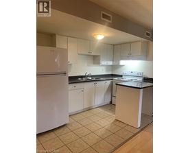 A kitchen with white appliances and white cabinets.