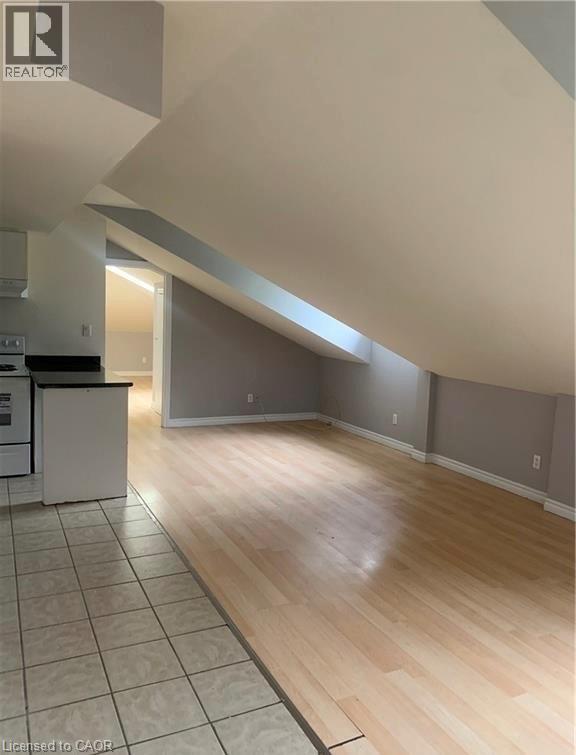 A kitchen with a white refrigerator and wooden floors.
