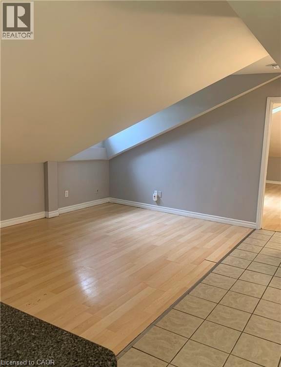 A room with wooden flooring and a skylight.