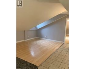 A room with wooden flooring and a skylight.