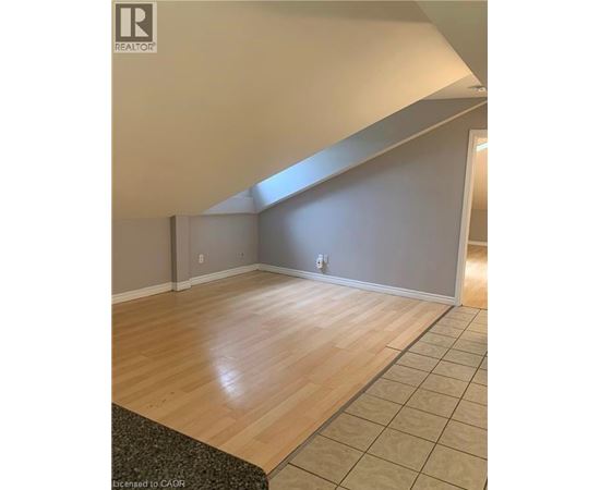 A room with wooden flooring and a skylight.