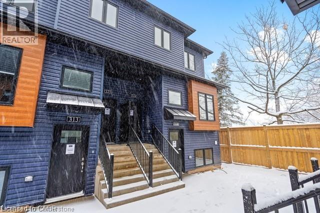 A blue house with a wooden fence in the snow.
