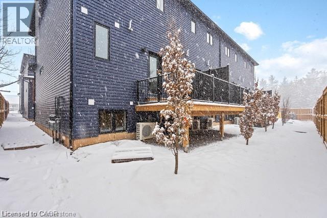 A snow-covered yard in front of a building.
