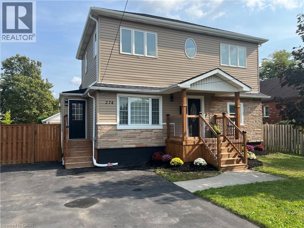 A two-story house with a garage and a deck.
