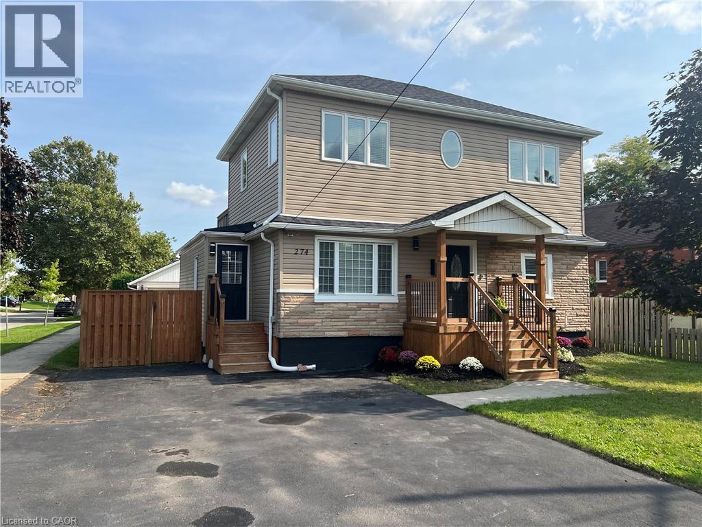 A two-story house with a garage and a deck.