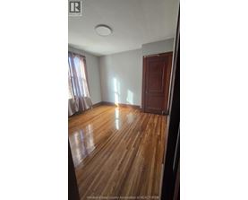 A room with wooden flooring and a closed door.