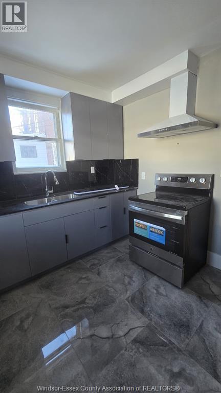 A kitchen with a black stove top oven.