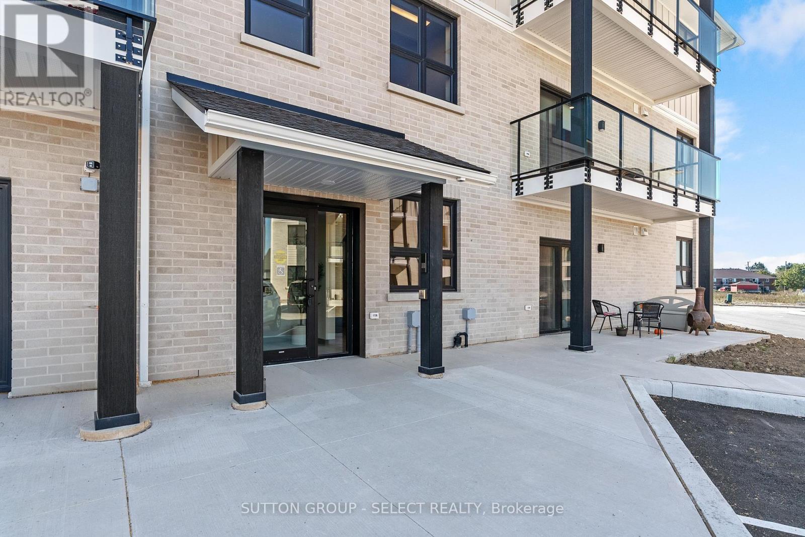 A modern building with a balcony and a glass door.