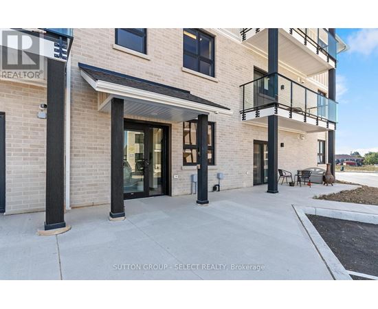 A modern building with a balcony and a glass door.