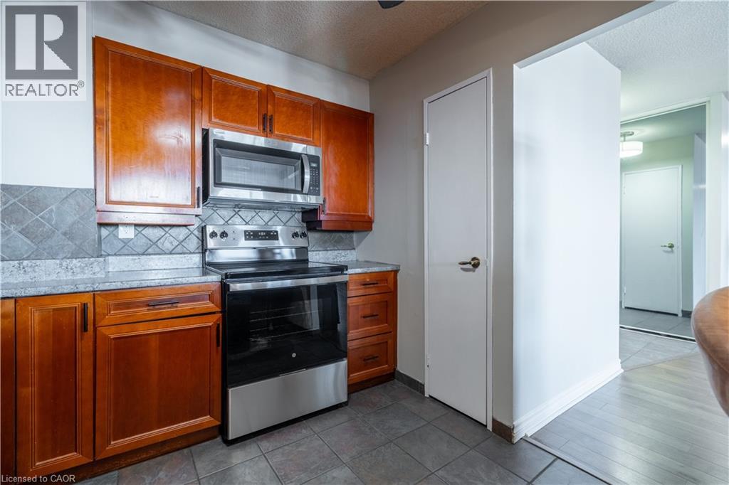 A kitchen with wooden cabinets and stainless steel appliances.