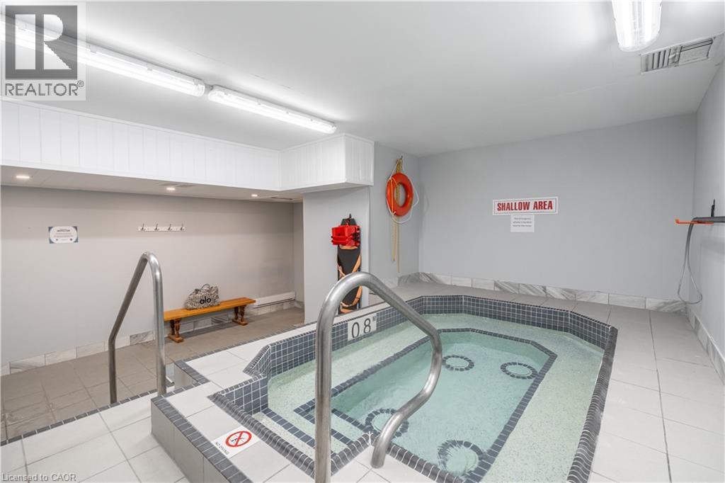 A swimming pool in a room with a sign that says "DANGER AREA".
