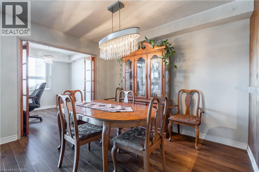 A dining room with a wooden table and chairs.