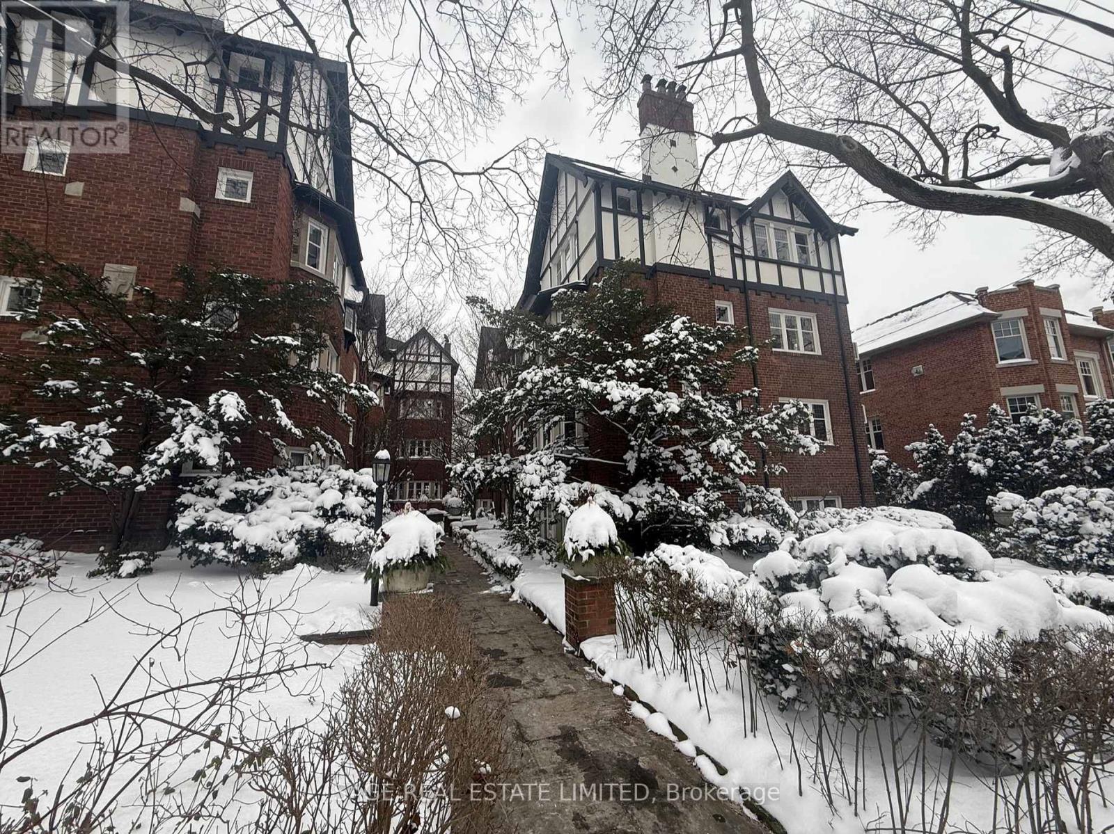 A snowy scene with a building and a sign that says "Estate Limited Broke".