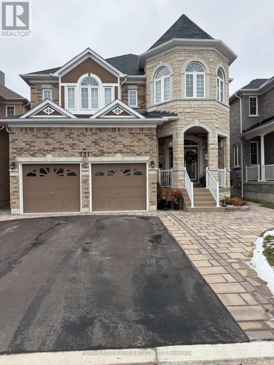A large house with a stone wall and a brown garage door.