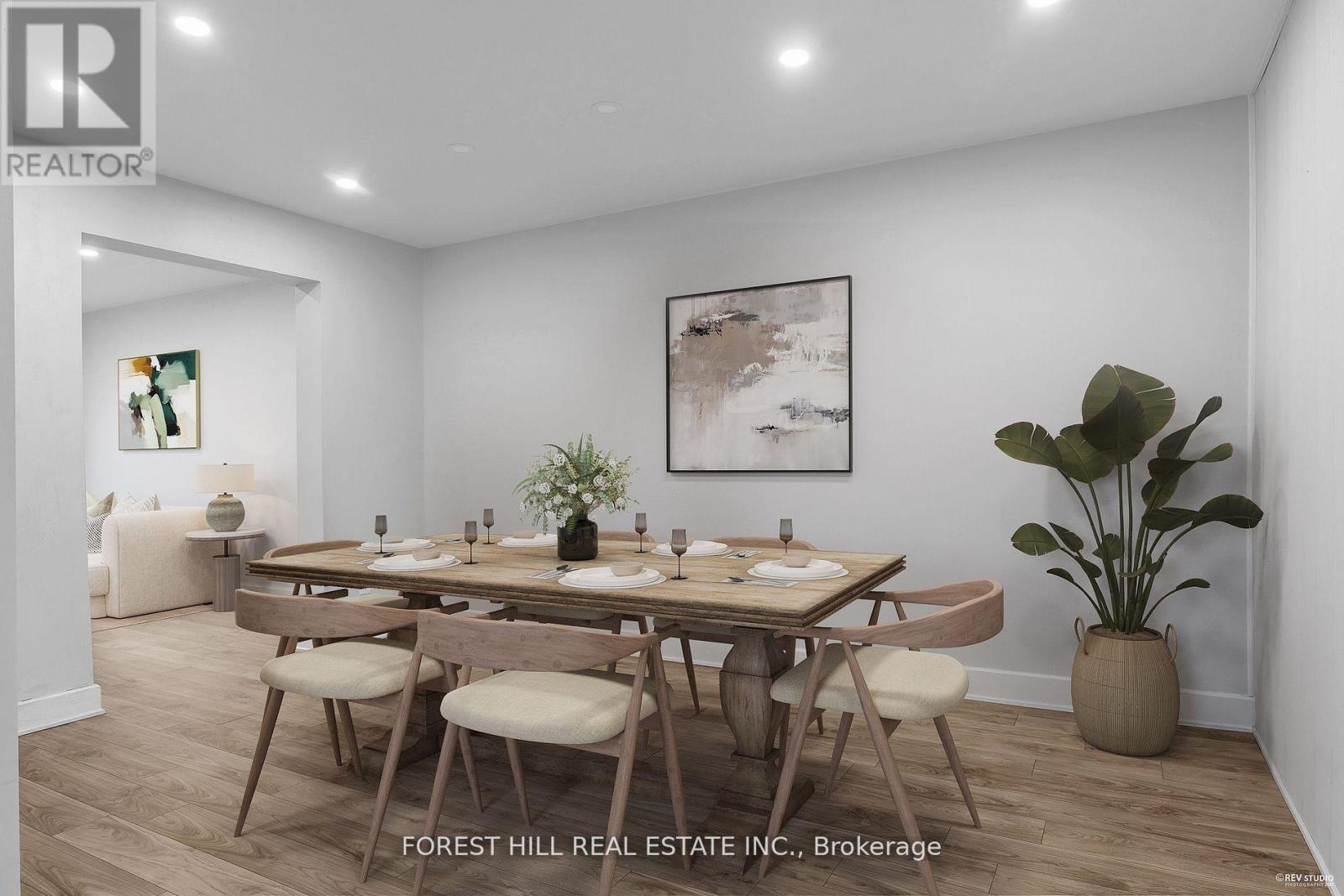 A dining room with a wooden table and chairs.