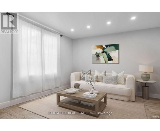 A living room with a white couch, a coffee table, and a painting on the wall.