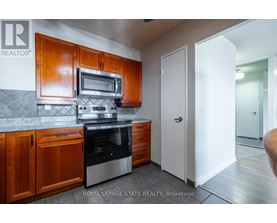A kitchen with wooden cabinets and stainless steel appliances.