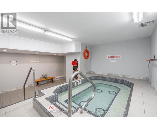 A swimming pool in a room with a sign that says "DANGER AREA".
