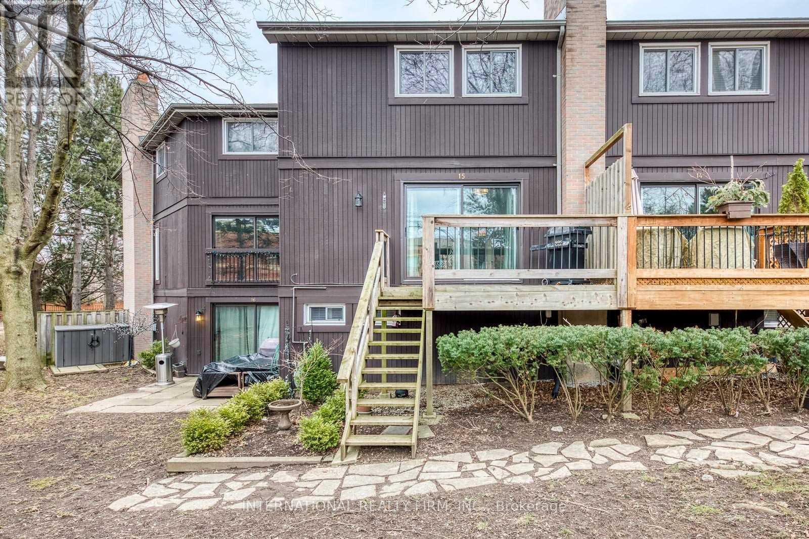 A house with a grey exterior and a wooden deck.