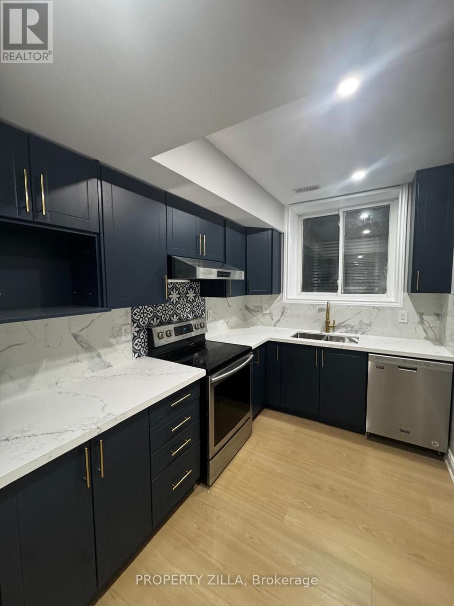 A kitchen with dark cabinets and a marble countertop.