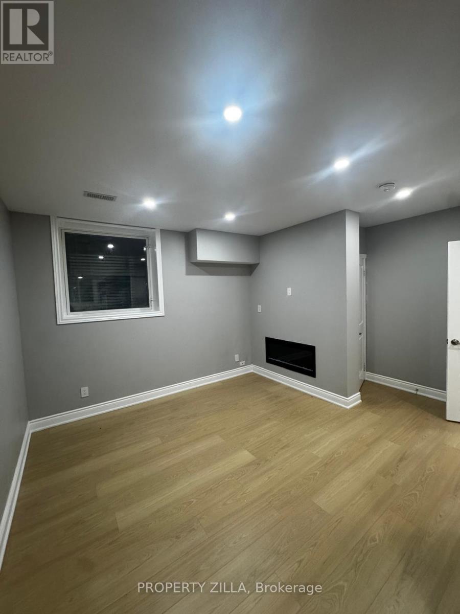 A room with a fireplace and a window.