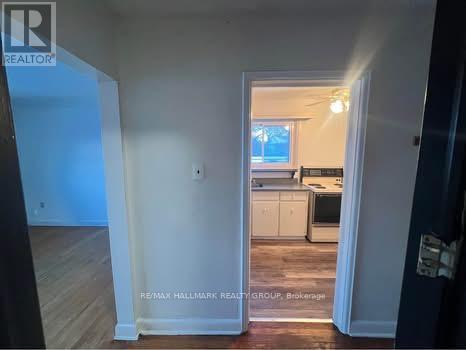 A room with a doorway leading to a kitchen.