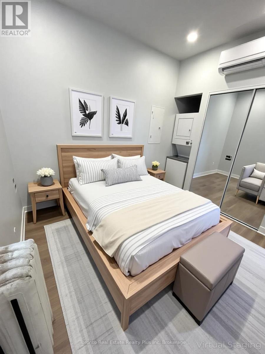 A bedroom with a large bed and two framed pictures on the wall.