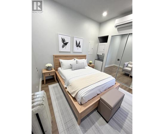 A bedroom with a large bed and two framed pictures on the wall.