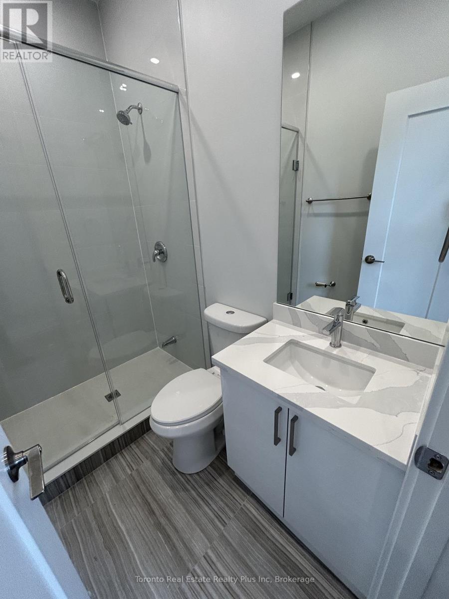A white toilet sits next to a sink in a bathroom.