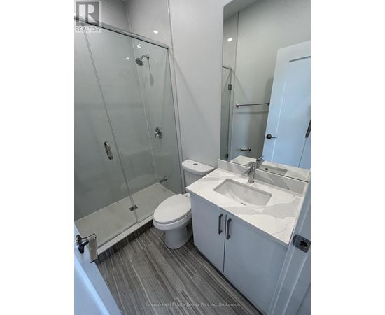 A white toilet sits next to a sink in a bathroom.