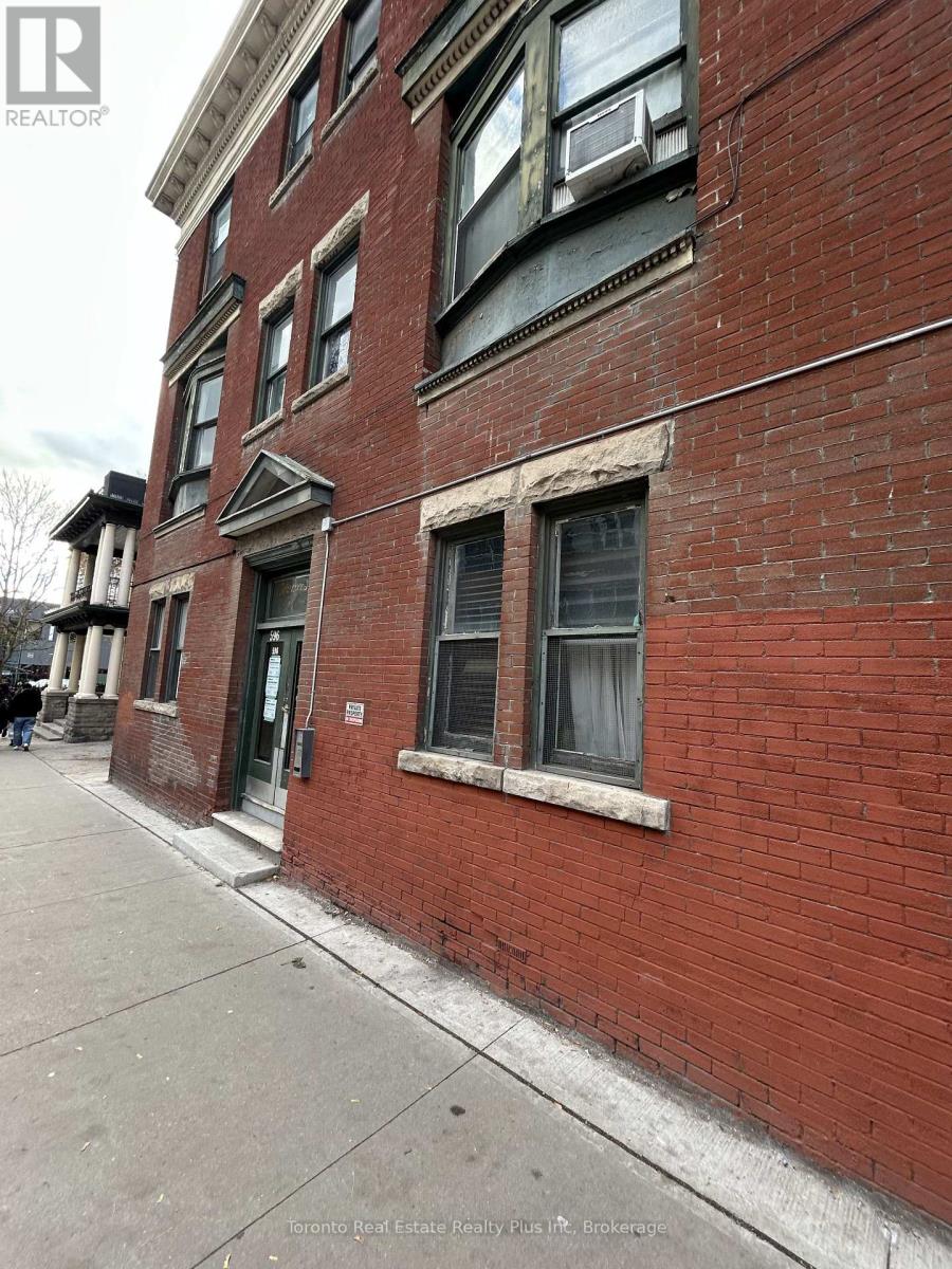 A red brick building with a window and a door.