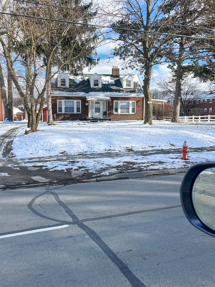 A house with a red fire hydrant in front of it.