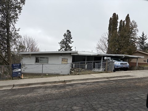 A house with a car parked in front of it.