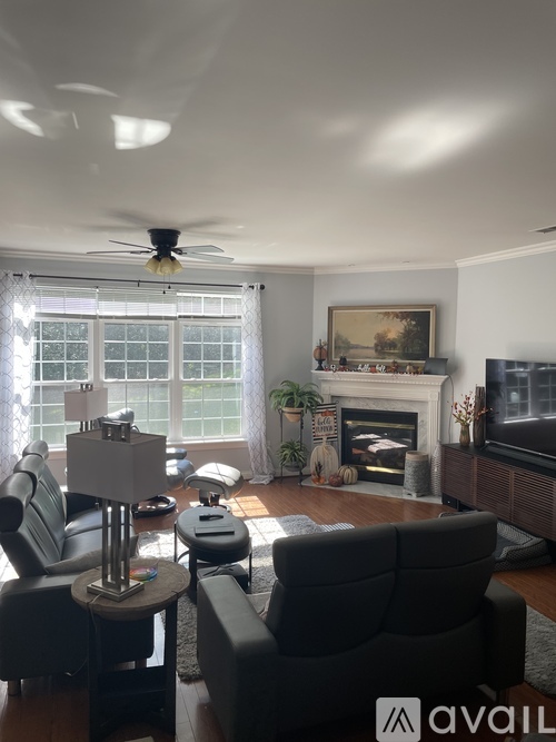 A living room with a fireplace and a painting on the wall.