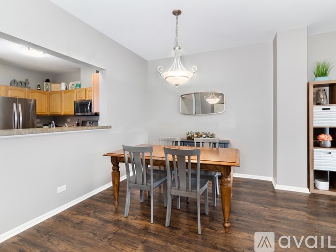 A dining room with a wooden table and chairs.