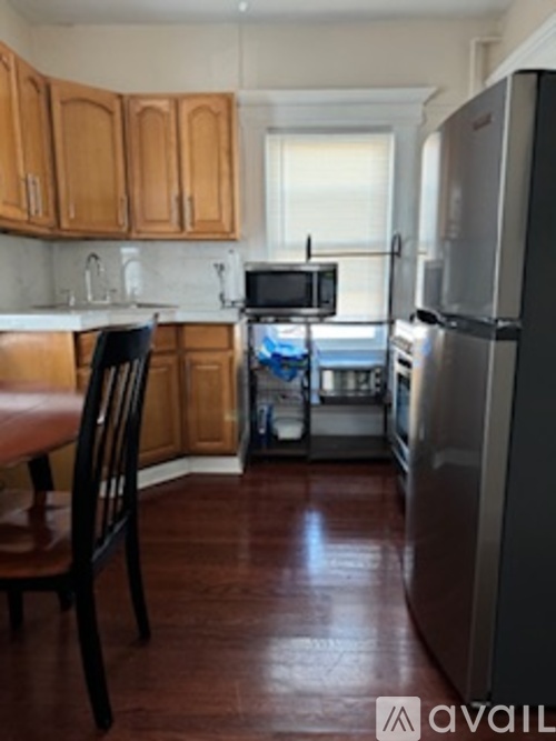 A kitchen with wooden cabinets and a refrigerator.
